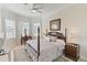 Spacious primary bedroom with a king-size bed and large windows at 4735 Cassio Ct, Bradenton, FL 34211