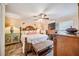 Bedroom featuring a starfish-patterned quilt, ceiling fan, and wooden furniture at 4888 Oak Pointe Way, Sarasota, FL 34233