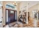 Elegant foyer featuring a decorative front door, tile floors, and views into the dining room at 4888 Oak Pointe Way, Sarasota, FL 34233