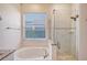 Spa-like bathroom with a large shower and soaking tub at 5919 Sandstone Ave, Sarasota, FL 34243