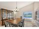 Dining room features a table for six and a view of the pool at 5919 Sandstone Ave, Sarasota, FL 34243