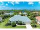 Single-story house with a teal roof, waterfront property at 1768 S Creek Ln, Osprey, FL 34229