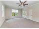 Bright bedroom with carpet flooring, ceiling fan and access to the outside at 1768 S Creek Ln, Osprey, FL 34229