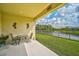 Covered patio with lake view and seating area for outdoor enjoyment at 5514 69Th E Pl, Ellenton, FL 34222