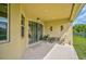 Relaxing covered patio with seating area and view of the backyard at 5514 69Th E Pl, Ellenton, FL 34222