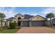 Two-story house with a three car garage and brick driveway at 5514 69Th E Pl, Ellenton, FL 34222