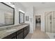 Double vanity bathroom with granite countertops and walk-in shower at 5514 69Th E Pl, Ellenton, FL 34222