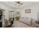 Home office with large windows, comfortable seating and built-in desk at 5514 69Th E Pl, Ellenton, FL 34222