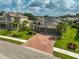 Two-story house with brick driveway and landscaped lawn at 5514 69Th E Pl, Ellenton, FL 34222