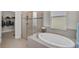 Relaxing bathroom with soaking tub, walk-in shower, and separate toilet at 5514 69Th E Pl, Ellenton, FL 34222