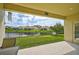 Covered patio overlooking a tranquil lake in a peaceful community at 5514 69Th E Pl, Ellenton, FL 34222