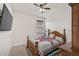 Bright bedroom with a queen-size bed and large TV at 5514 69Th E Pl, Ellenton, FL 34222