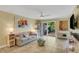Living room with tiled floors, sofa and patio access at 3413 Clark Rd # 114, Sarasota, FL 34231