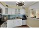 Well-equipped kitchen with white cabinets, granite countertops, and stainless steel appliances at 3413 Clark Rd # 114, Sarasota, FL 34231