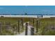 Beach access path with wooden posts and sandy walkway at 3413 Clark Rd # 114, Sarasota, FL 34231