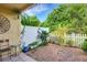 Private patio with brick pavement and lush greenery at 3413 Clark Rd # 114, Sarasota, FL 34231