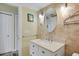 Updated bathroom with a white vanity and textured walls at 3413 Clark Rd # 114, Sarasota, FL 34231
