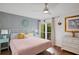 Spacious bedroom with a king-size bed, soft pink bedding, and ceiling fan at 3413 Clark Rd # 114, Sarasota, FL 34231