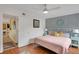 King-size bed, light pink bedding, and a view of the hallway at 3413 Clark Rd # 114, Sarasota, FL 34231