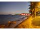 Night view of a bridge, water, and palm trees at 4821 Silver Topaz St, Sarasota, FL 34233