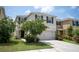 Two-story house with a two car garage and landscaped front yard at 4821 Silver Topaz St, Sarasota, FL 34233