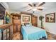 Bedroom with a built-in wooden cabinet and a ceiling fan at 4888 Oak Pointe Way, Sarasota, FL 34233