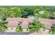 Aerial view of homes with lakefront access and lush surroundings at 3152 Windrush Bourne # 22, Sarasota, FL 34235