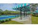 Pickleball courts with seating area under striped canopy at 7217 Churston Ln, University Park, FL 34201