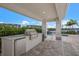Covered outdoor kitchen area with grill and seating at 10748 Klee Ave, Bradenton, FL 34212