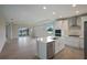 Modern kitchen with white cabinets, island, and stainless steel appliances at 10748 Klee Ave, Bradenton, FL 34212