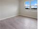 Spacious bedroom featuring a large window and wood-look tile floors at 10748 Klee Ave, Bradenton, FL 34212