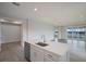 Modern kitchen with white cabinets and island overlooking living area at 10748 Klee Ave, Bradenton, FL 34212