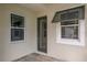 Front entry with glass door and gray window shutters at 10748 Klee Ave, Bradenton, FL 34212