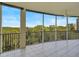 Private screened balcony with scenic views and ceiling fan at 393 N Point Rd # 503, Osprey, FL 34229