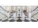 Elegant lobby with a checkered floor, seating area, and grand staircase at 393 N Point Rd # 503, Osprey, FL 34229