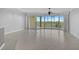 Bright living room with tile floors and sliding glass doors leading to a balcony with preserve views at 393 N Point Rd # 503, Osprey, FL 34229