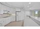 White kitchen with stainless steel appliances and a breakfast bar at 393 N Point Rd # 503, Osprey, FL 34229