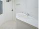 White laundry room with washer, dryer, cabinets, and utility sink at 393 N Point Rd # 503, Osprey, FL 34229