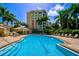 Resort-style pool with surrounding lounge chairs and a building in the background at 393 N Point Rd # 503, Osprey, FL 34229