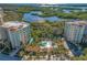 Aerial view of condo complex with pool and lush landscaping at 393 N Point Rd # 503, Osprey, FL 34229