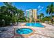 Relaxing pool and hot tub area with plenty of lounge chairs at 393 N Point Rd # 503, Osprey, FL 34229