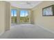 Bright bedroom with carpet flooring and large windows with nature views at 393 N Point Rd # 503, Osprey, FL 34229