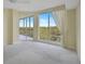 Bedroom with carpet floors and sliding glass doors to a balcony at 393 N Point Rd # 503, Osprey, FL 34229