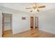 Bedroom with hardwood floors, ceiling fan, and closet at 433 Central Ave, Sarasota, FL 34236