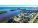 Stunning aerial view of waterfront condos featuring a pool, well manicured lawn, and beautiful ocean views at 4360 Chatham Dr # F204, Longboat Key, FL 34228