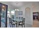 Formal dining room with glass table and decorative artwork at 5266 Pinehurst Ct, North Port, FL 34287