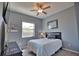 Cozy bedroom with a queen bed, ceiling fan, and window at 5266 Pinehurst Ct, North Port, FL 34287