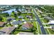 Aerial view of a beautiful community with single-Gathering homes, a lake, and lush landscaping at 5266 Pinehurst Ct, North Port, FL 34287