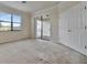 Primary bedroom with carpet, sliding doors to patio, and walk-in closet at 12656 Felice Dr, Venice, FL 34293