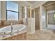 Bathroom with soaking tub and separate shower at 12656 Felice Dr, Venice, FL 34293